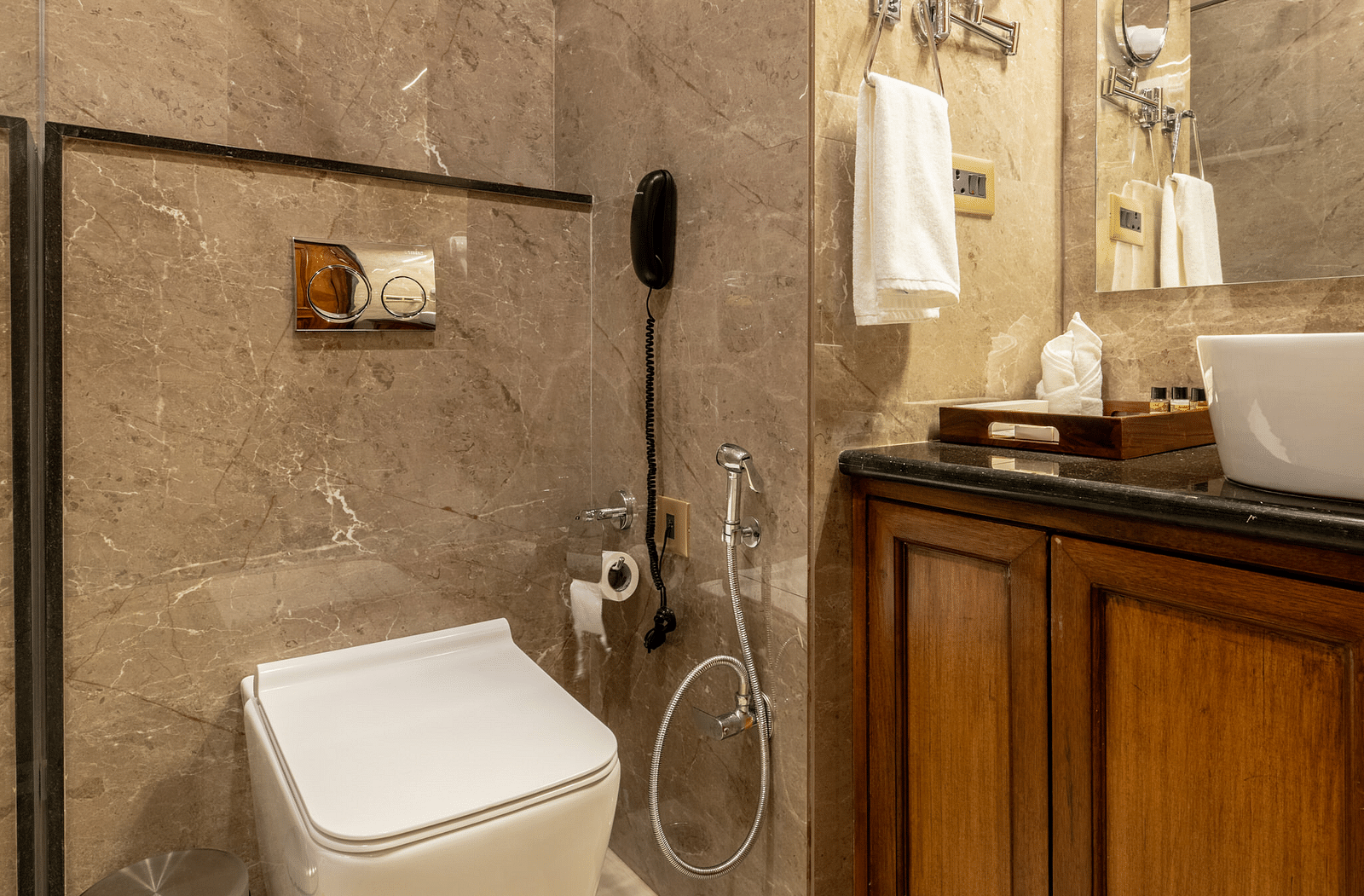 a bathroom featuring a commode right besides the vanity area - Brij Castle, Jaipur