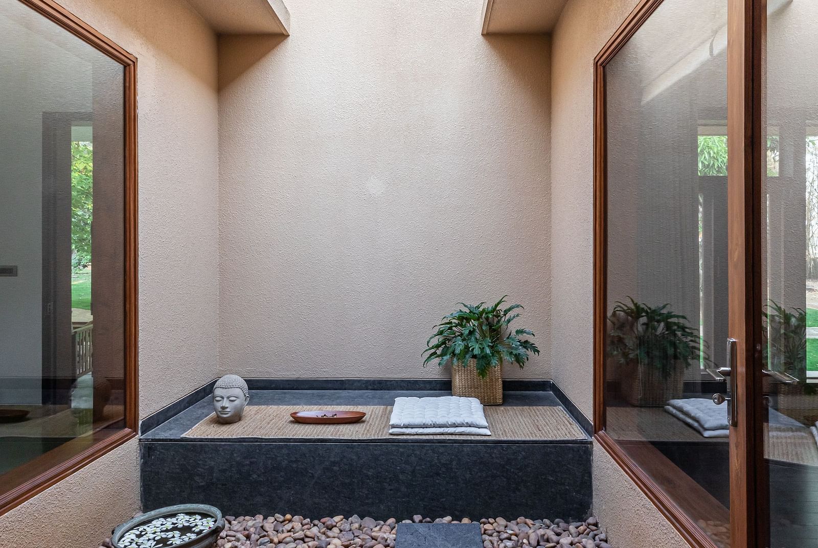 Bathroom with a dark bathtub, stone pebbles, skylight, natural light, modern design - Shreyas Retreat