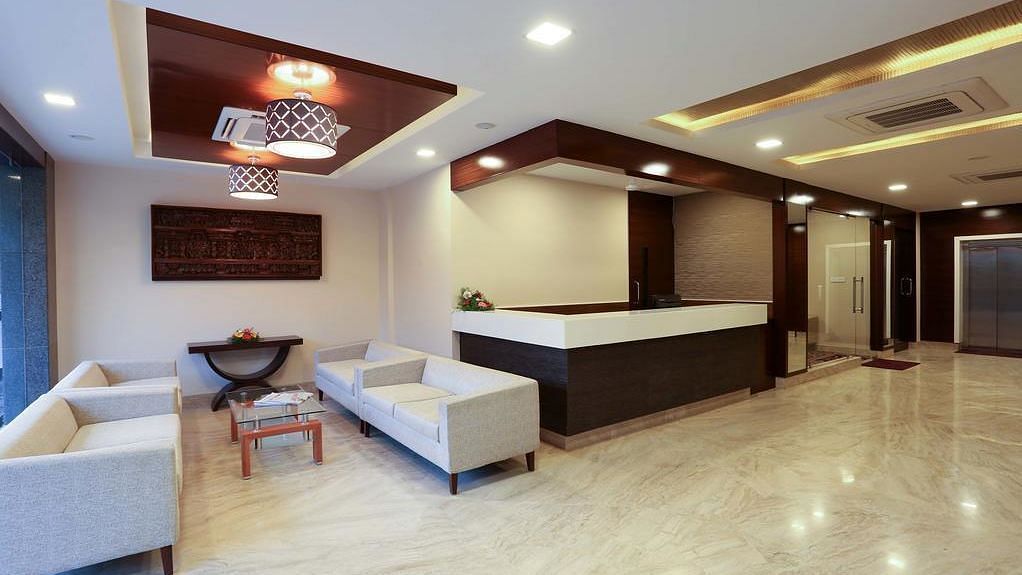 Siting area with two sets of spacious sofa and a coffee table at Fressotel Seetharam, Coimbatore