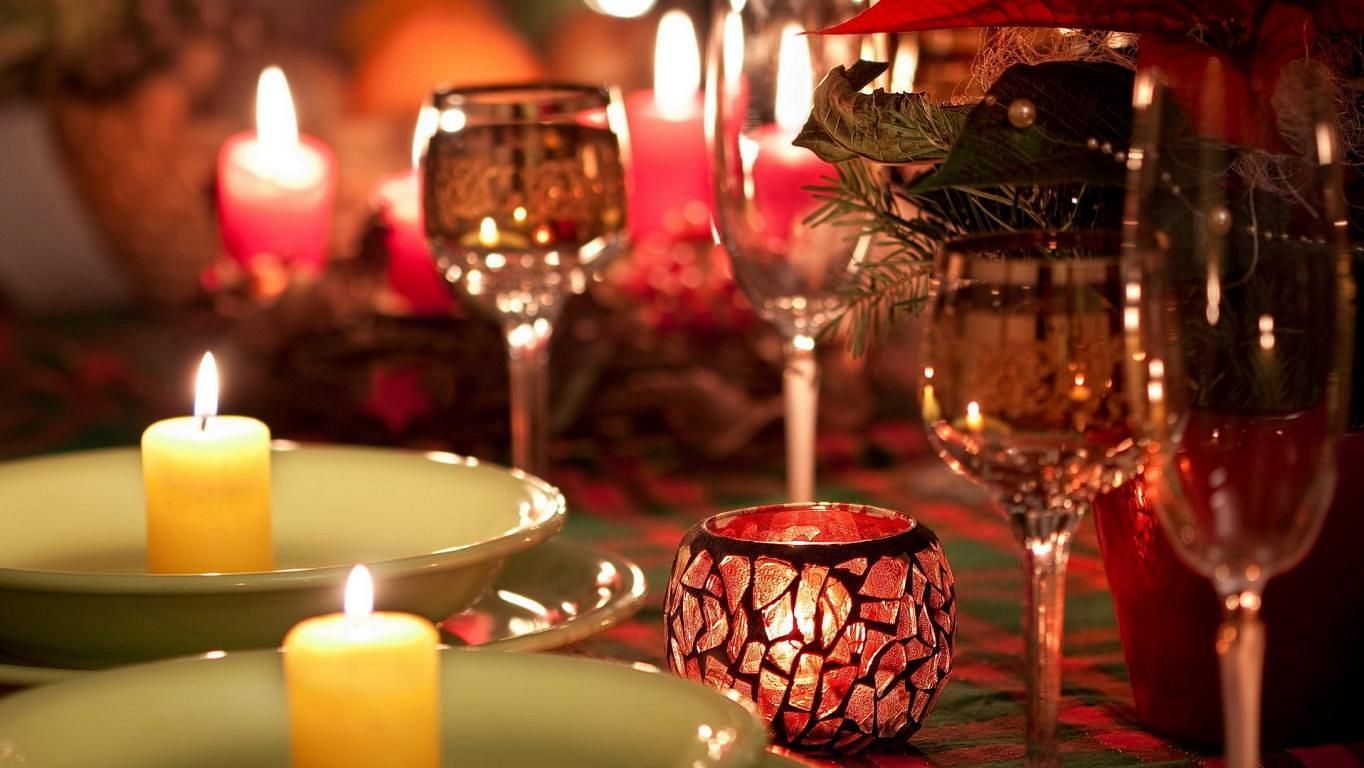 Image of a table with glasses and candles on it at Parampara Resort & Spa, Kushalnagar.