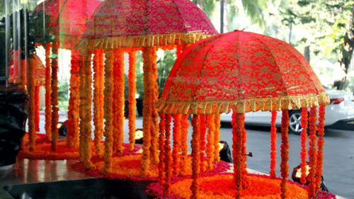  An ornate pavilion with arches and decorated with garlands.