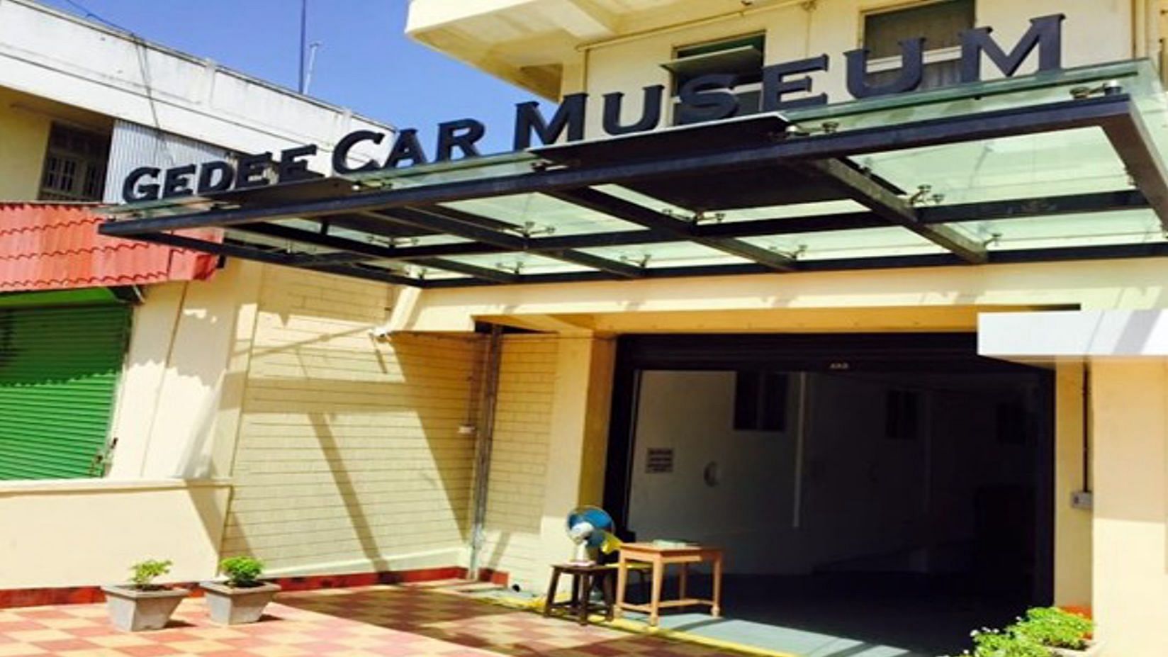 The exterior of a building with a sign that reads Gedee Car Museum.