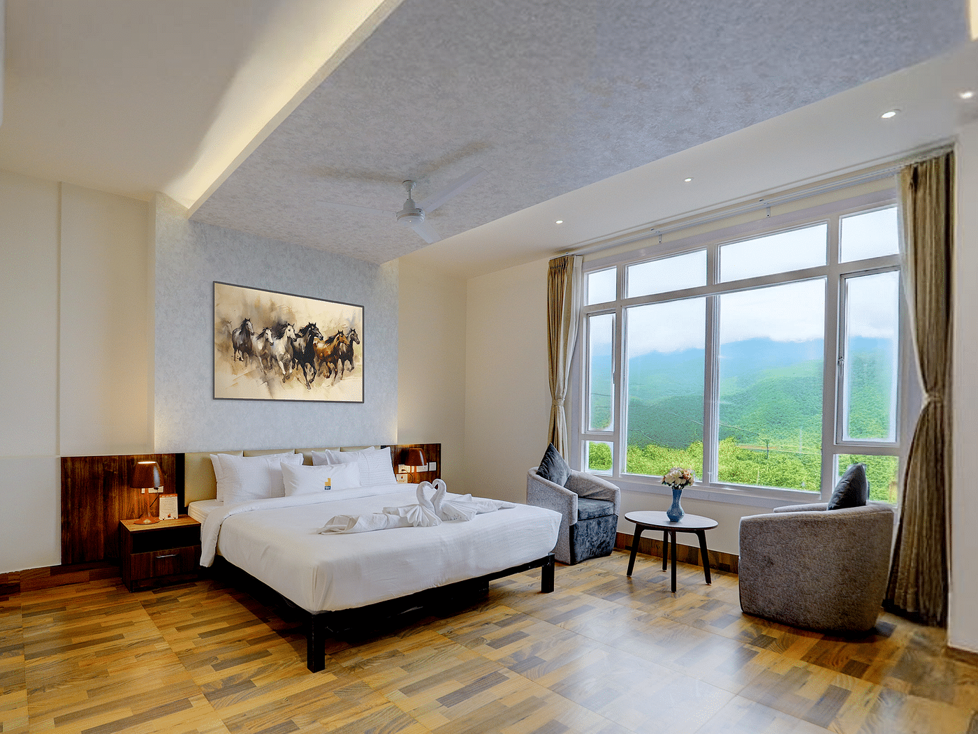 Image of a room with a bed and a large window on the side at Banari Regency by Summit, Namchii.