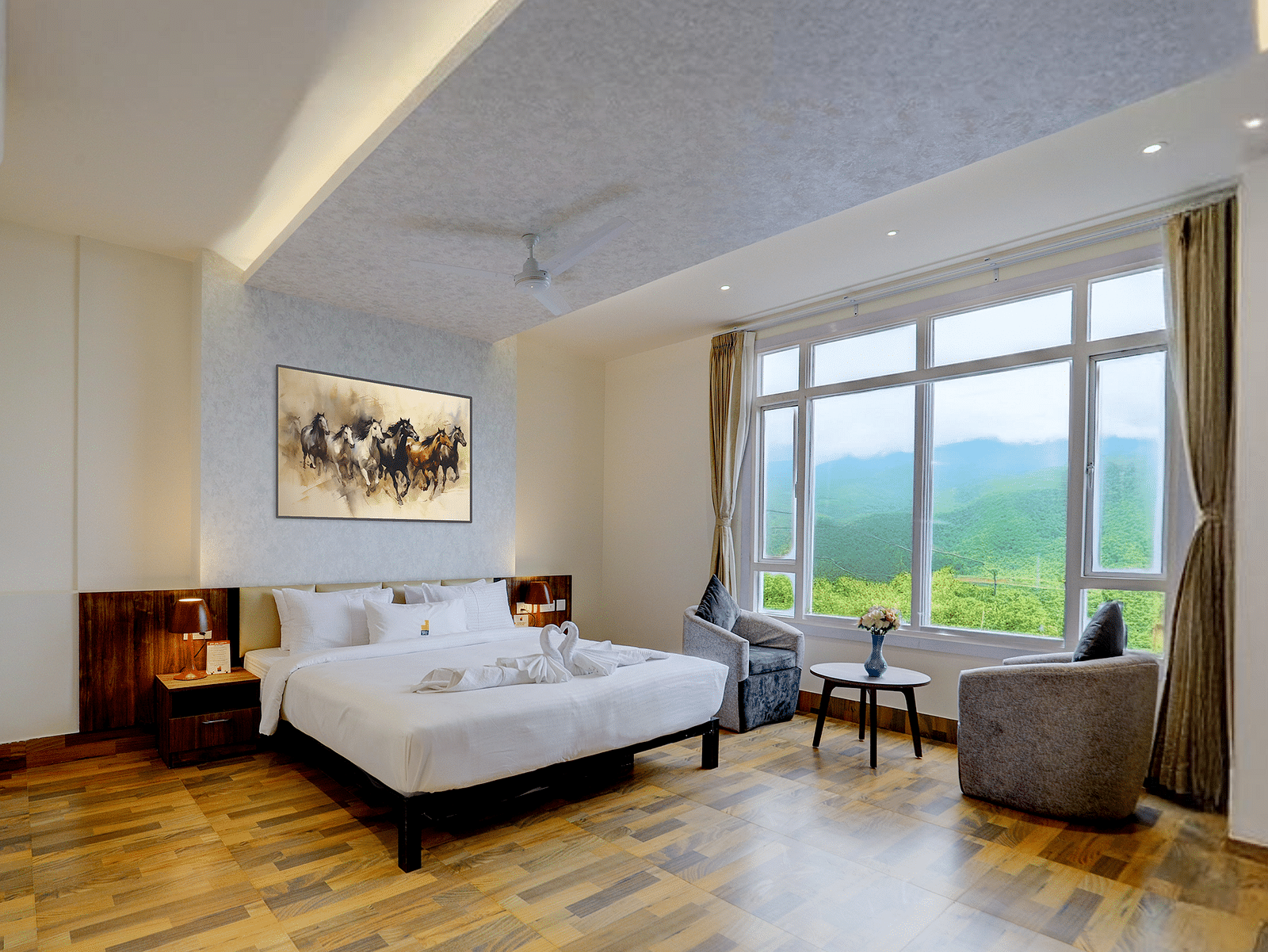 Image of a room with a bed and a large window on the side at Banari Regency by Summit, Namchii.