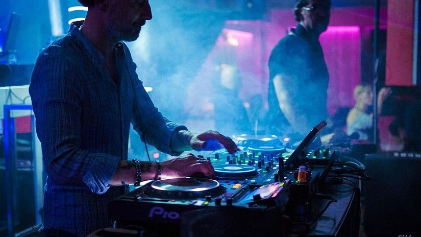 A DJ mixing songs in a nightclub