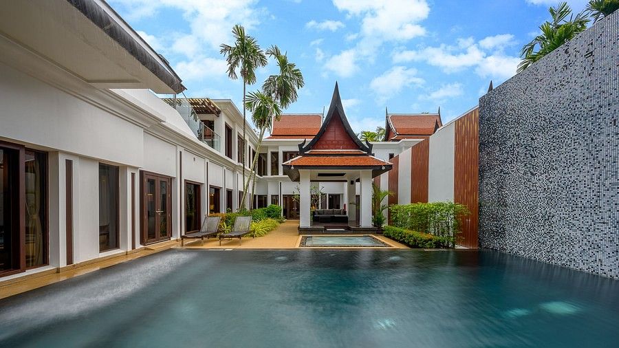 image of the exterior of the villas featuring a swimming pool in the foreground - two bedroom private pool villa
