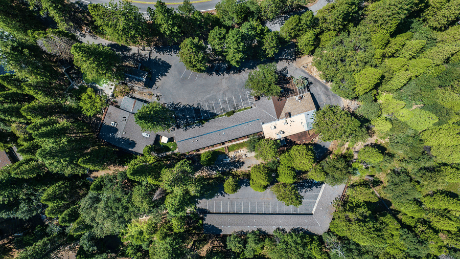 A top down aerial view of the property in the middle of the forest - Narrow Gauge Inn - A Serenite Hotel Near Fish Camp.