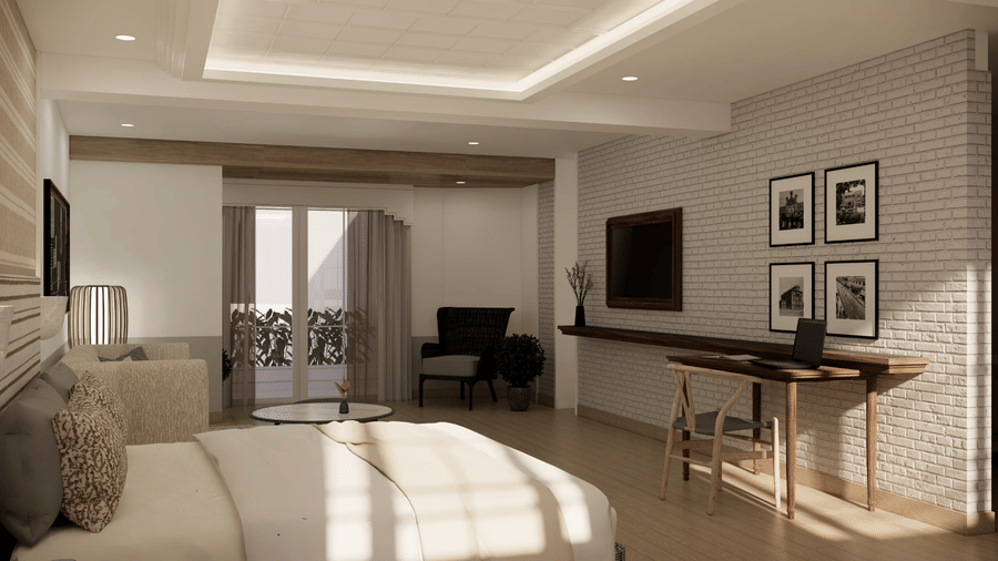 A room with a king size bed, a desk with a laptop, an armchair in the corner, and a balcony entrance at Shilton Suites, Bengaluru.