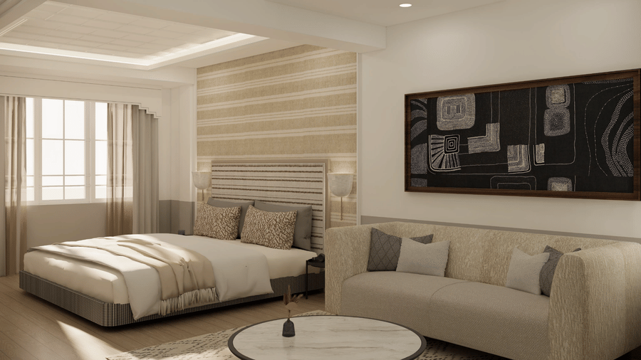 A room featuring a king size bed with a striped headboard, a light-coloured sofa, and a round coffee table at Shilton Suites, Bengaluru.