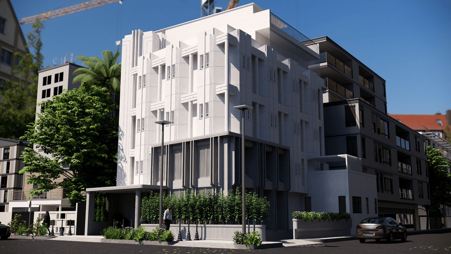 Exterior view of a 5-storey white contemporary building of Shilton Suites, Bengalurur, with green hedges at the base and a clear blue sky above.