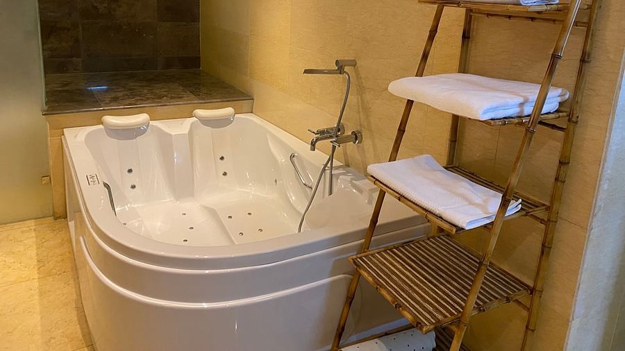 Bathroom with a standalone jacuzzi tub and towel rack at The Boma Nairobi.