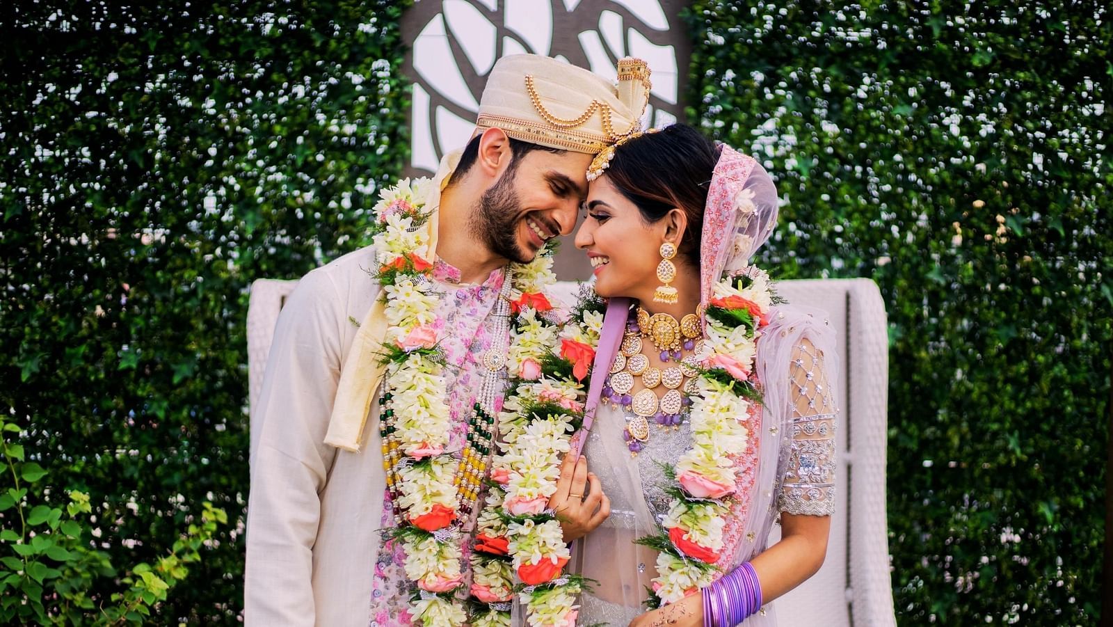a Couple posing for a picture after getting married - Rhythm Kumarakom