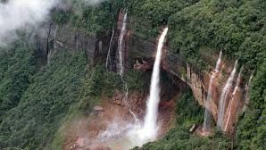 view of a hill with a waterfall cascading down 5