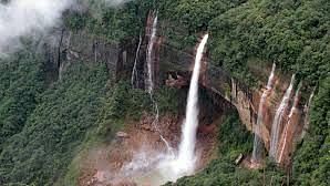 view of a hill with a waterfall cascading down 5