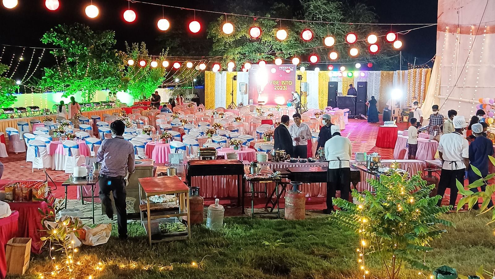 An event at our banquet hall in Tuticorin, with people engaged in conversations, set against a backdrop of a dark sky illuminated by lights around the venue - Regency Tuticorin by GRT Hotels