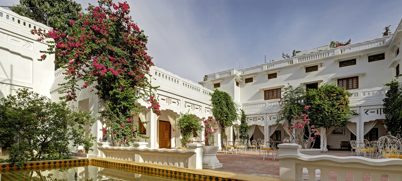 Facade of Saraca Lucknow featuring trees with flowers