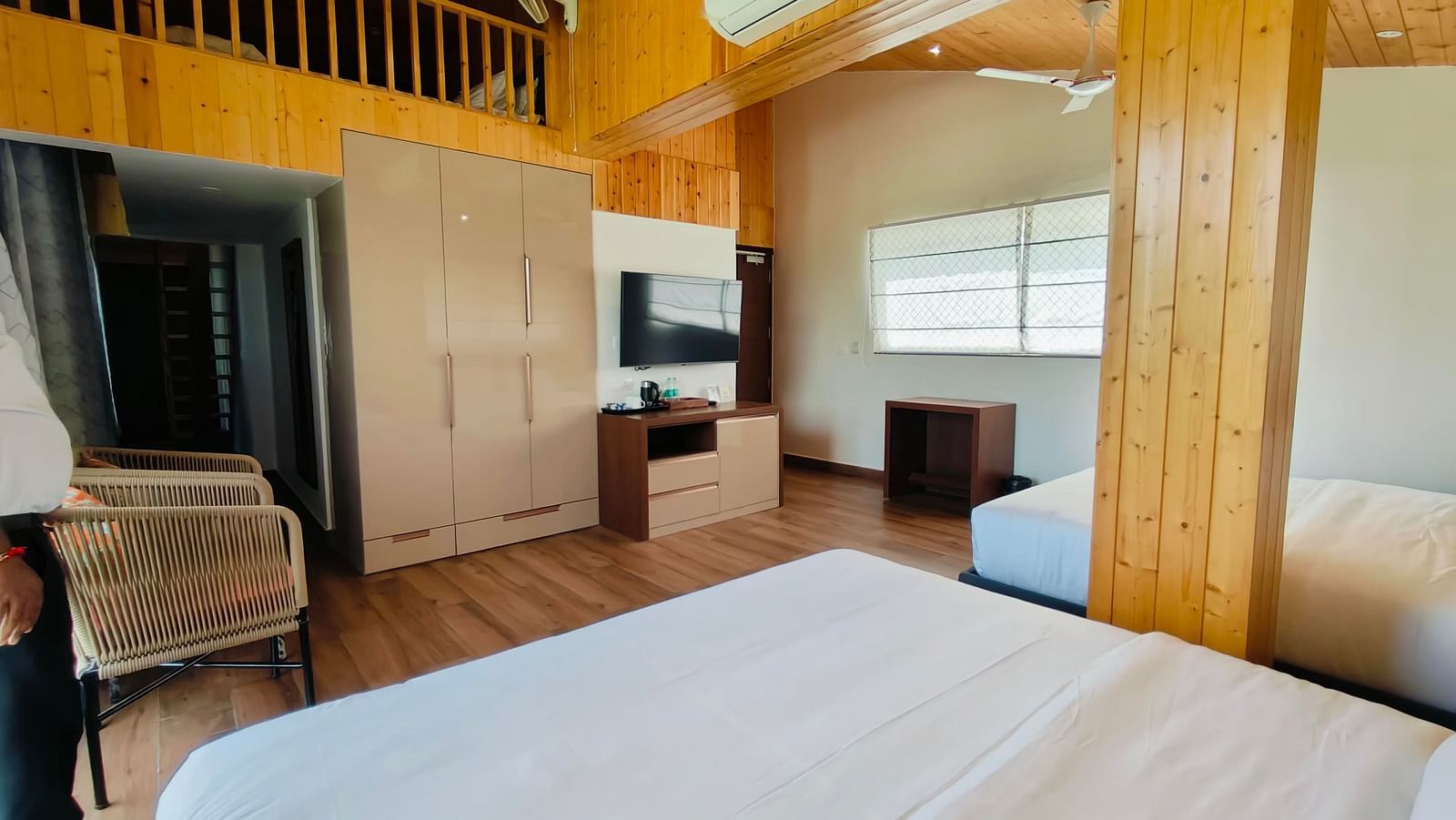 a family suite with wooden interiors at Eminence The Corbett with two beds in the room