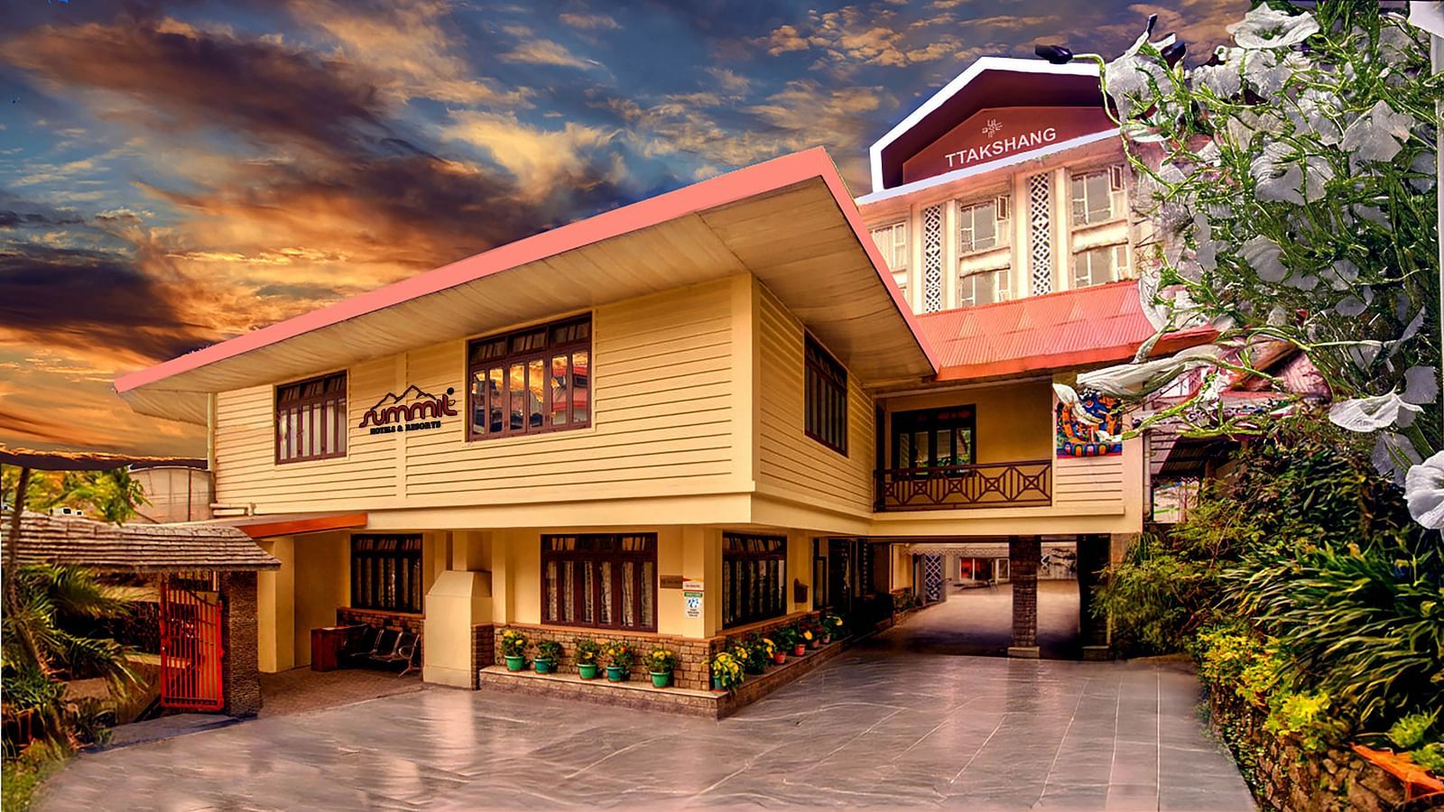 Facade of Summit Ttakshang Residency Hotel & Spa, Gangtok, with a sunset-lit cloudy sky and trees lining the pathway