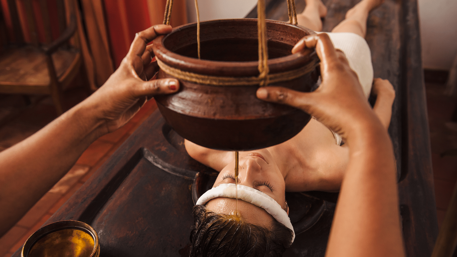 an image of Shirodhara treatment - Kerala Ayurveda - Rhythm Kumarakom
