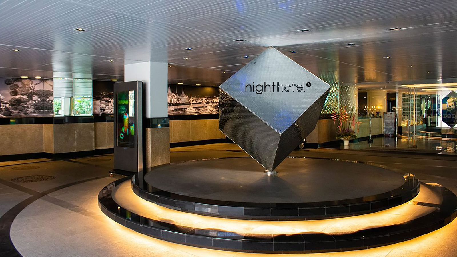Entrance view of Night Hotel Bangkok with the name engraved on a black cube.