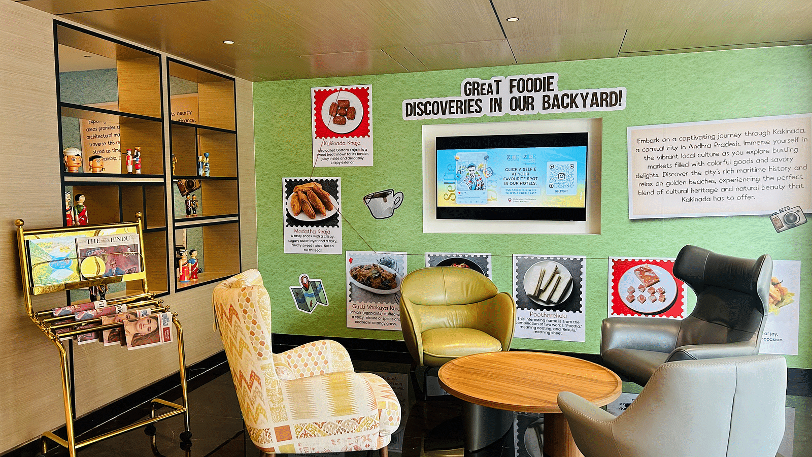 an image of a lobby with posters and newspapers at Zibe Luxe Kakinada by GRT Hotels