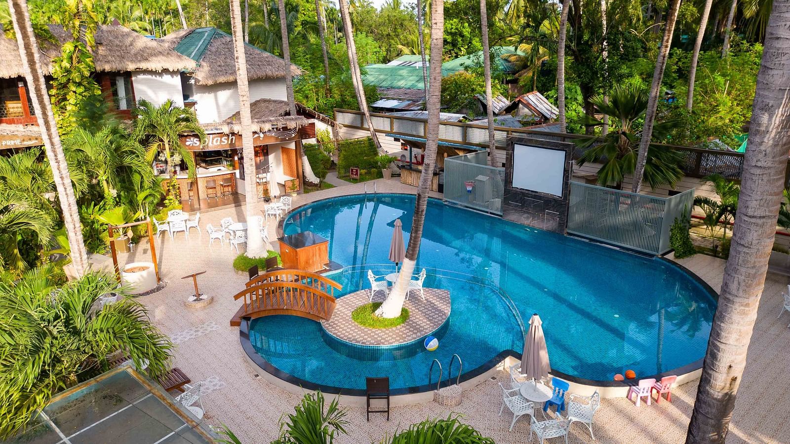  A bird's-eye view of the resort with pools, gardens, and modern facilities. The tropical setting includes palm trees and lounge areas, enhancing the resort's natural appeal - Coral Reef Resort & Spa, Havelock