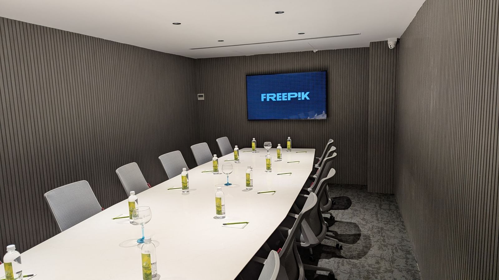 Boardroom with arranged seating and water bottles at Fressotel, Kanakapura Road, Bangalore.