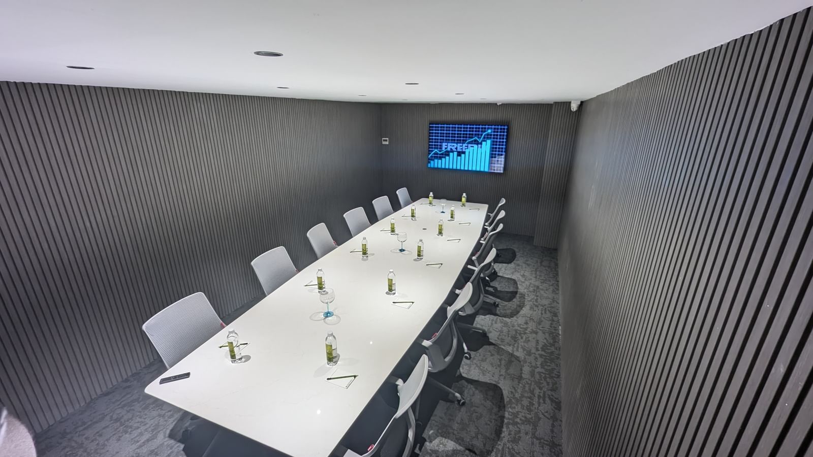Modern meeting space with long table and chairs at Fressotel, Kanakapura Road, Bangalore.