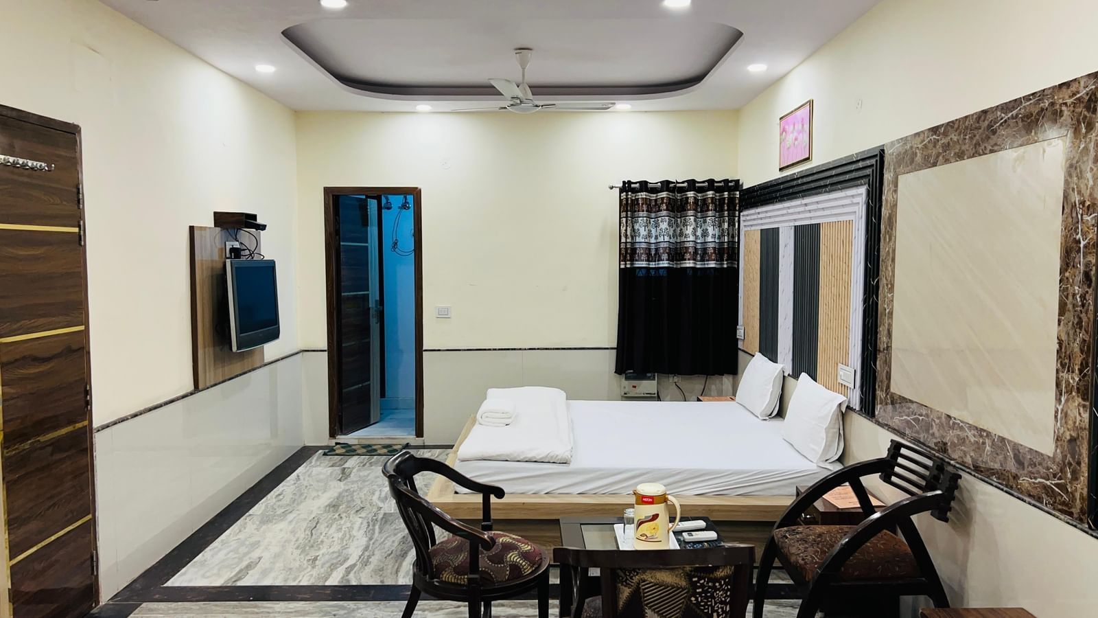 A hotel room with two beds and a seating area, designed for comfort and functionality. | Family Room | Hotel City Palace DX