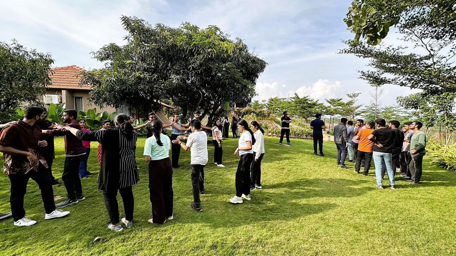 A group of people at Ravishing Retreat invested in group activities outdoor on a sunny day on the lawn