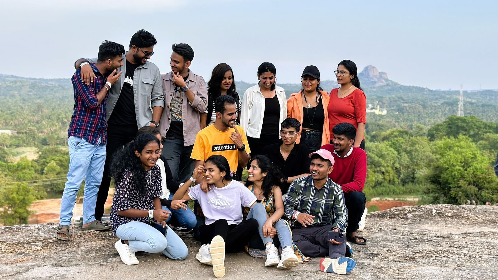A candid shot of a group of people at Ravishing Retreat talking to each other and smiling with a scenic view in the background