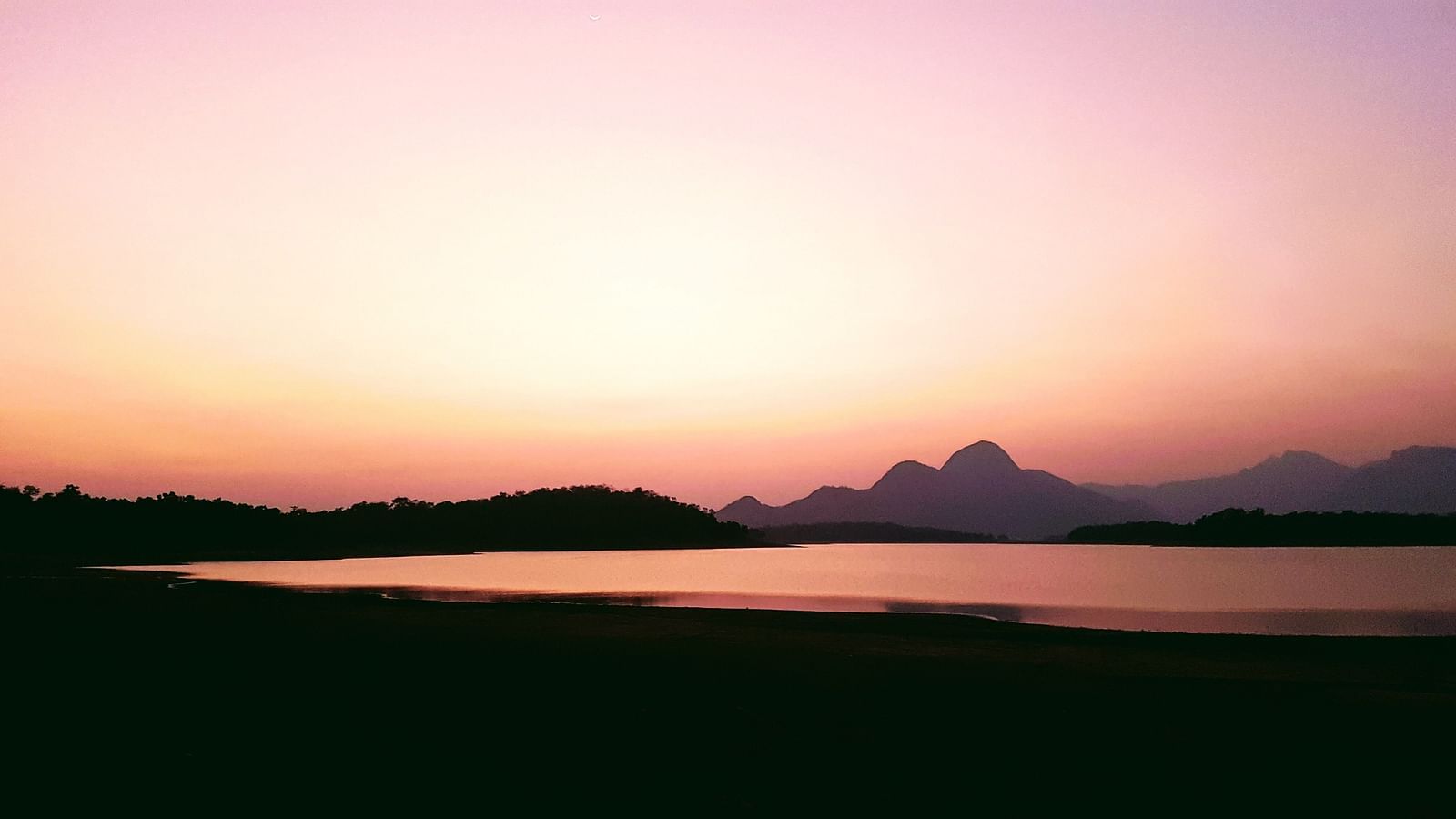 An overview of a lake with the evening sky after sun set in the background