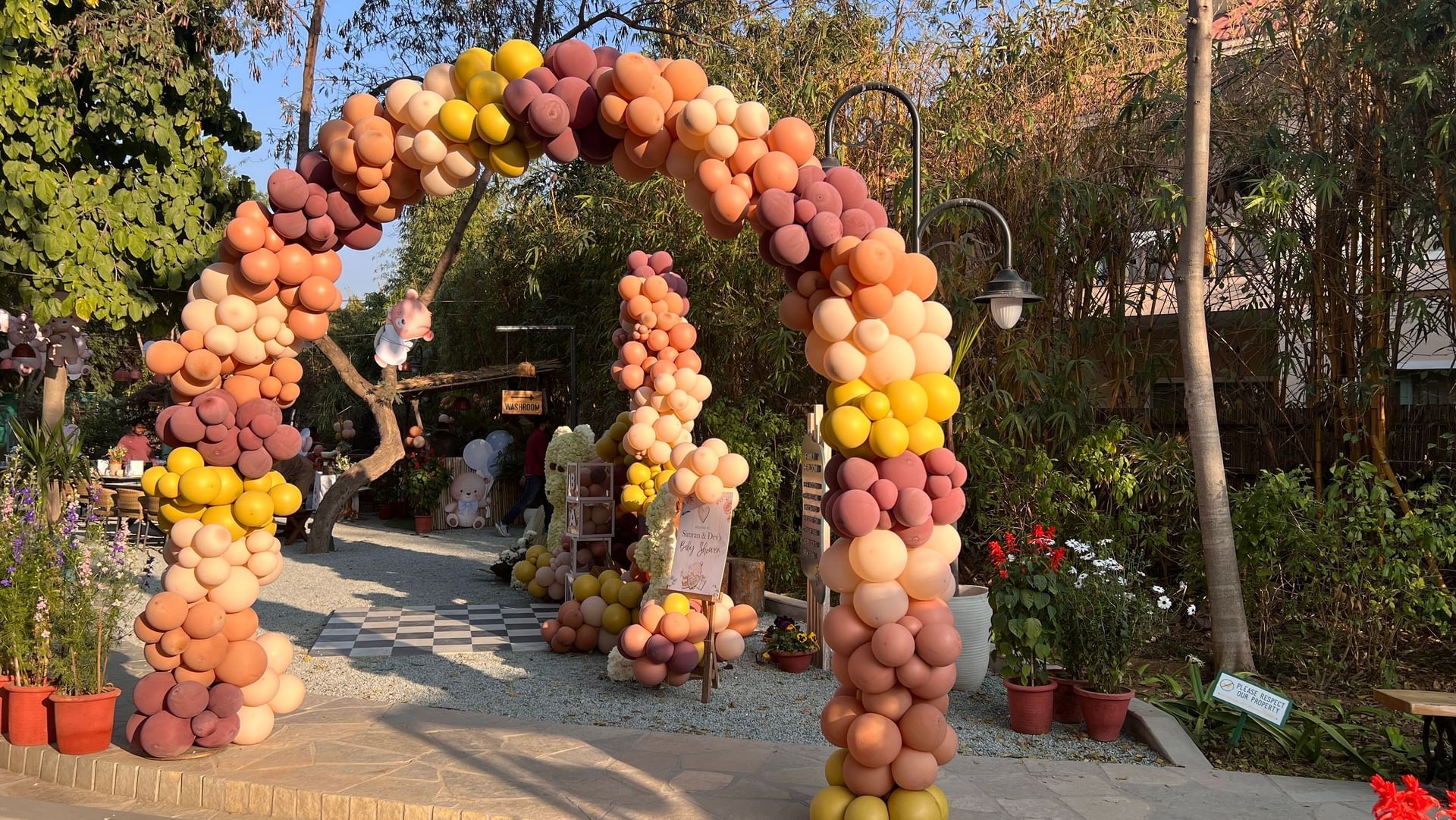 Colorful floral and balloon archway welcoming guests at Karma Chalets.