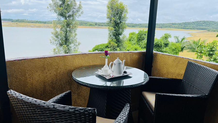 Image of a sitting area with a view of a water body in front at Coorg Jungle Camp Backwater Resort, Kushalnagar.