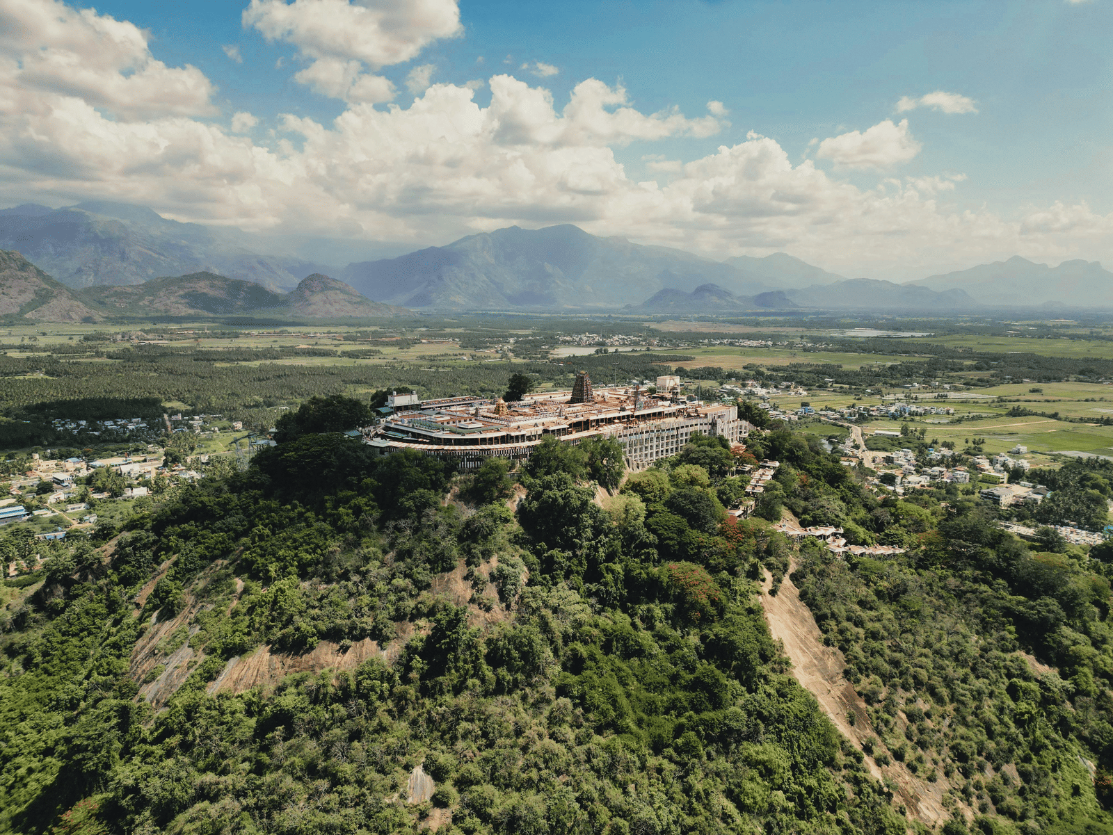 Aerial view of a fort on a hill surrounded by greenery.