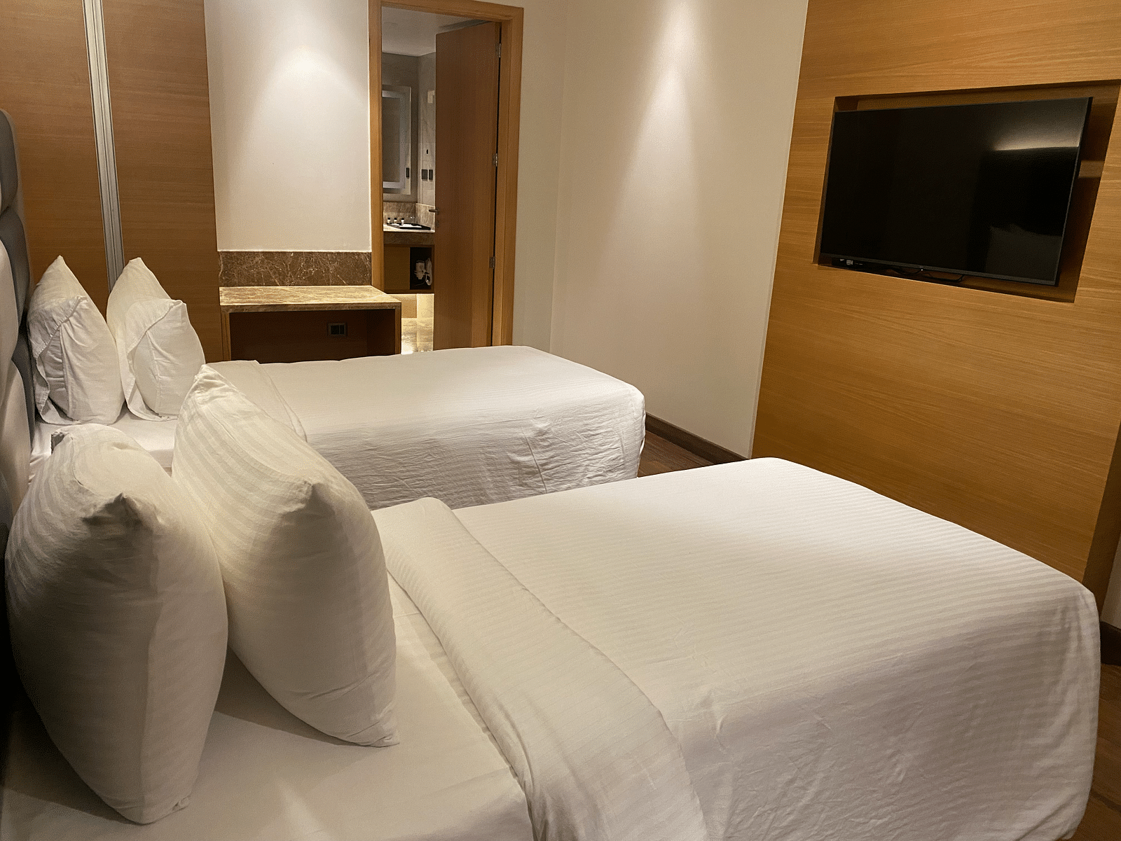 A top Premium Twin room  shot with cosy bed, TV at SRM Hotel Maram Malai Nagar, Chennai