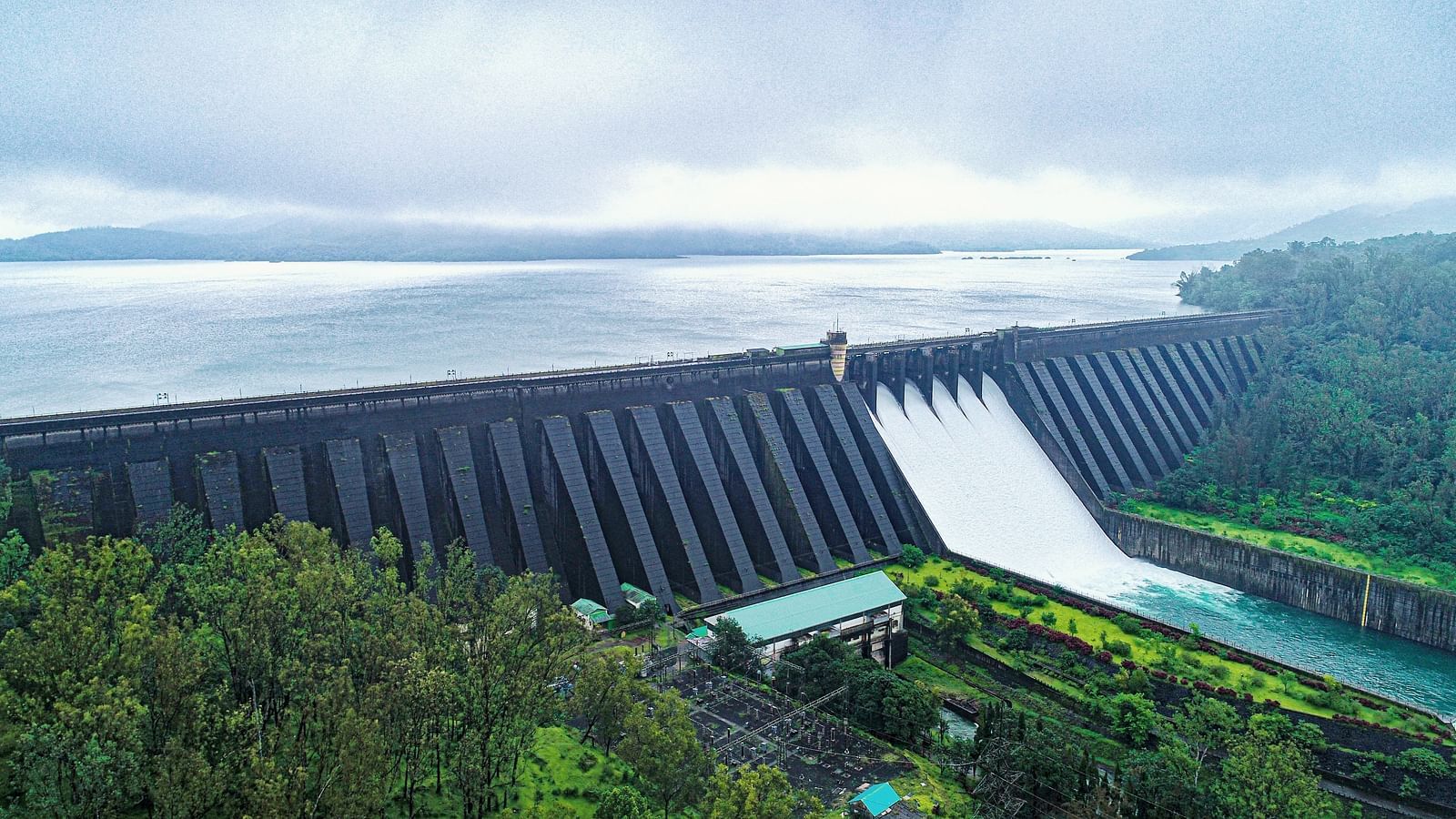 Another view of the massive Konya dam with water flowing through spillways