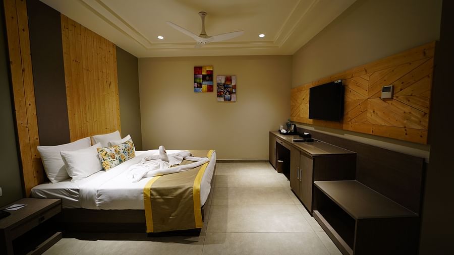 a room decked with a bed and television at Five Elements Hotels Maplewood Premier, Haldwani