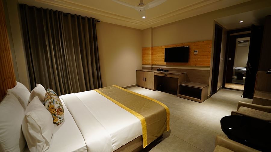 a comfortable bed decked with a television at Five Elements Hotels Maplewood Premier, Haldwani