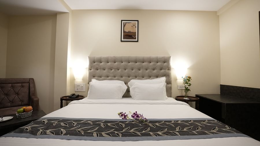 Cosy room setup with a neatly made bed, armchair, and minimalist decor at The Verda de Miranda Resort.