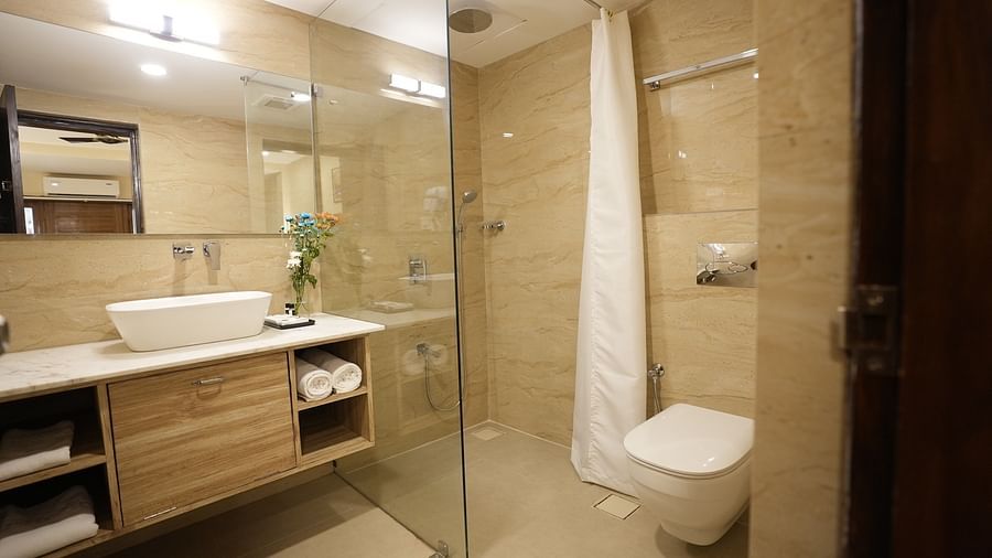 Contemporary bathroom with glass shower enclosure, vanity unit, and elegant lighting at The Verda de Miranda Resort.