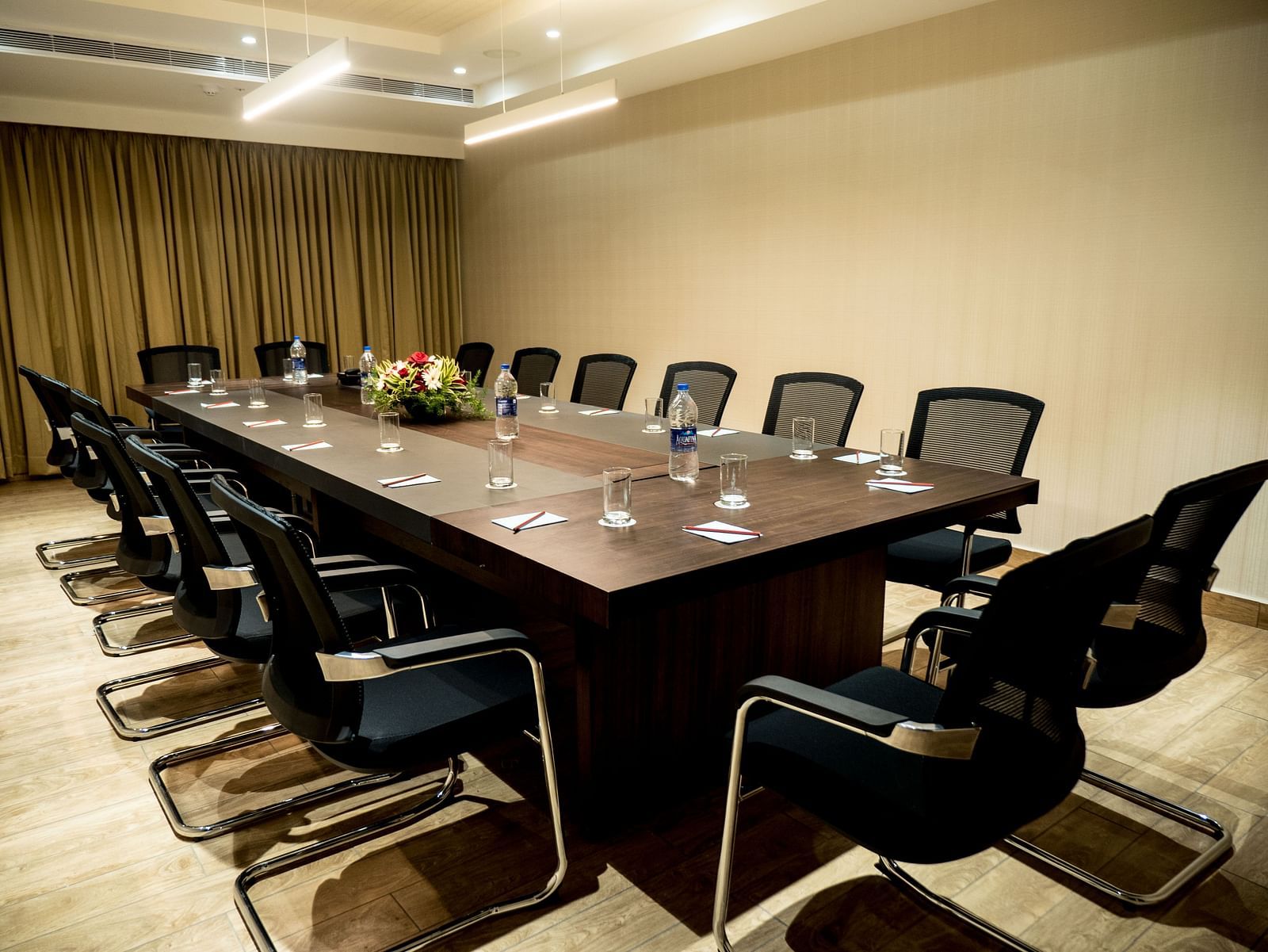 An image of a board room with chairs surrounding a table.
