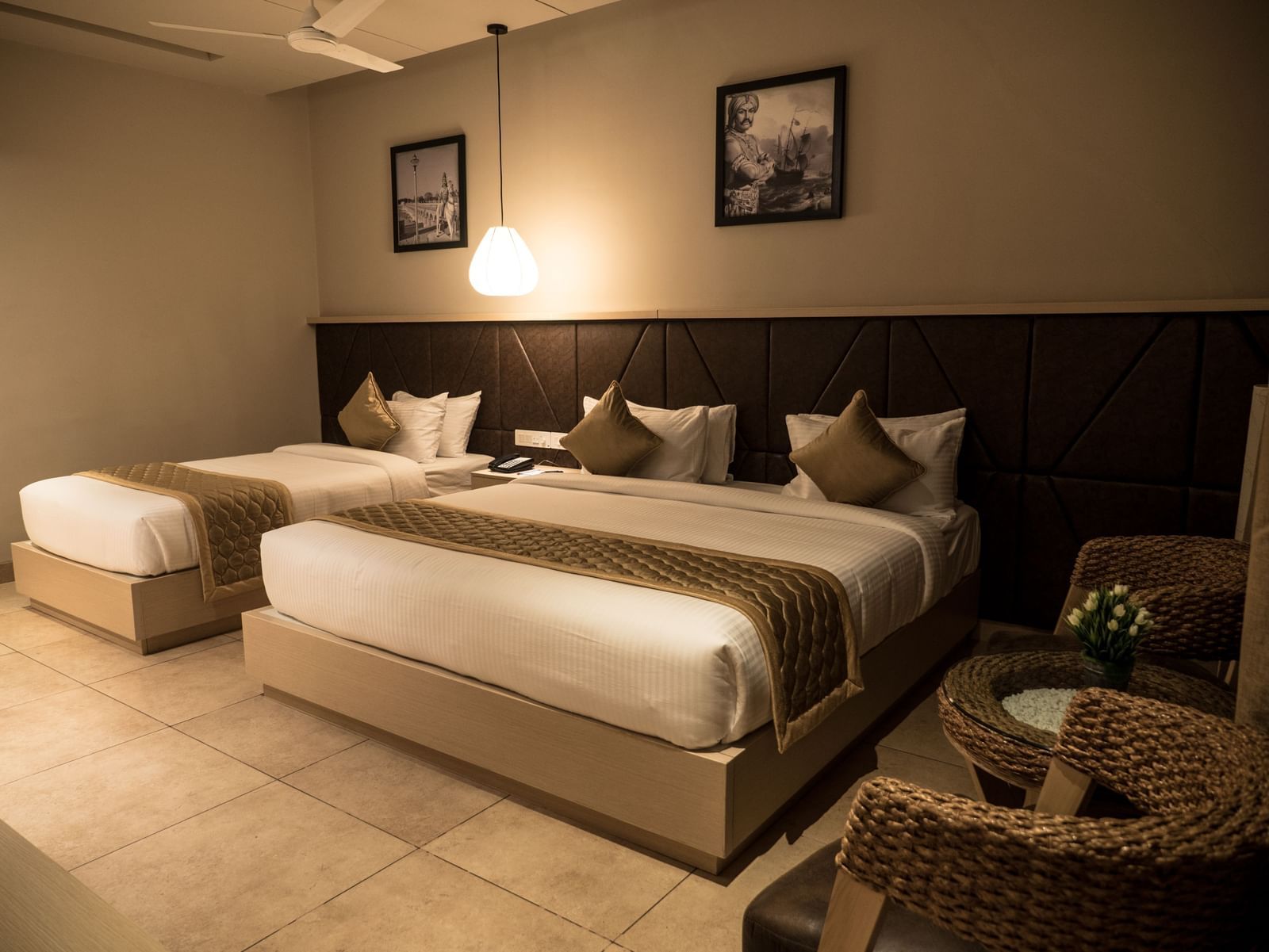 view of a king size bed and a single bed at Executive Tripple Room at Cholaa Dynasty, Kumbakonam