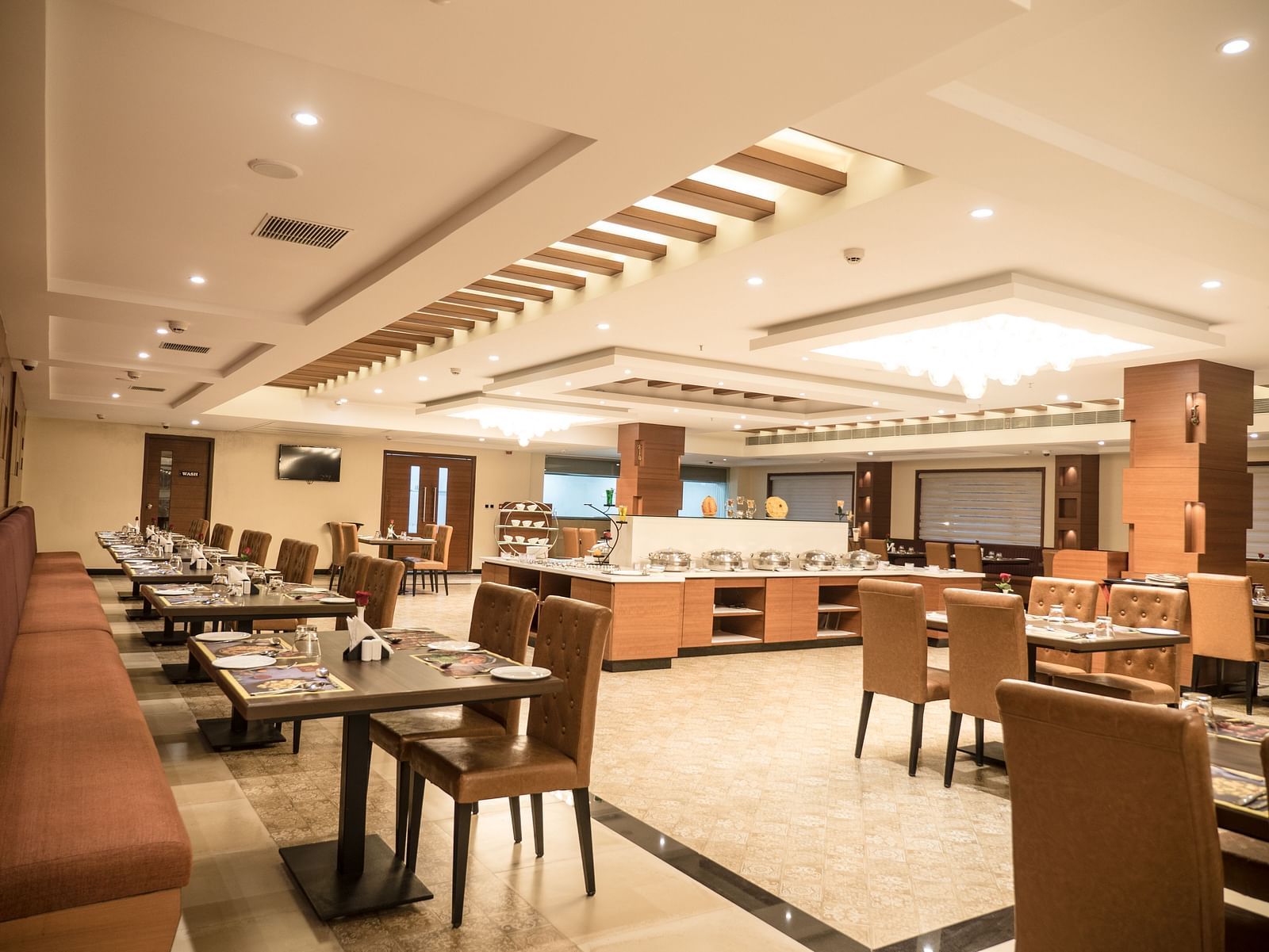 dining of a restaurant with warm lights of MM Legacy, Kanchipuram