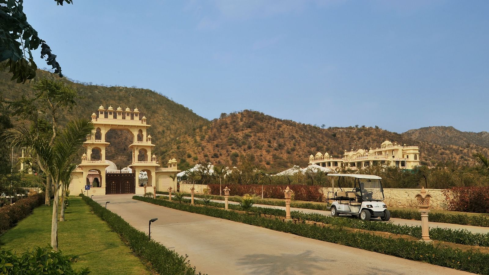 Image of a pathway with mountains in the background at Rajasthali Resort & Spa Jaipur.