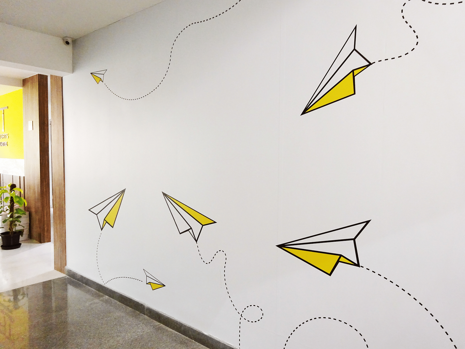 An office wall with paper plane illustrations on them.