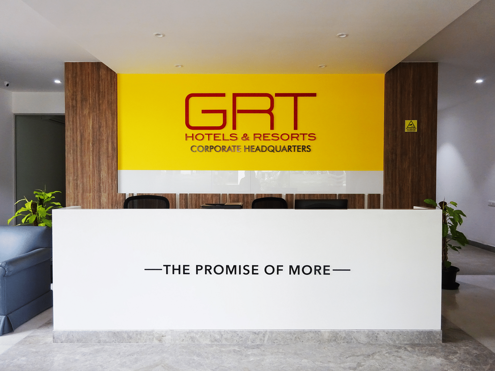 Reception area of GRT Hotel and Resorts Corporate headquarters with a tag line saying-the promise of more.