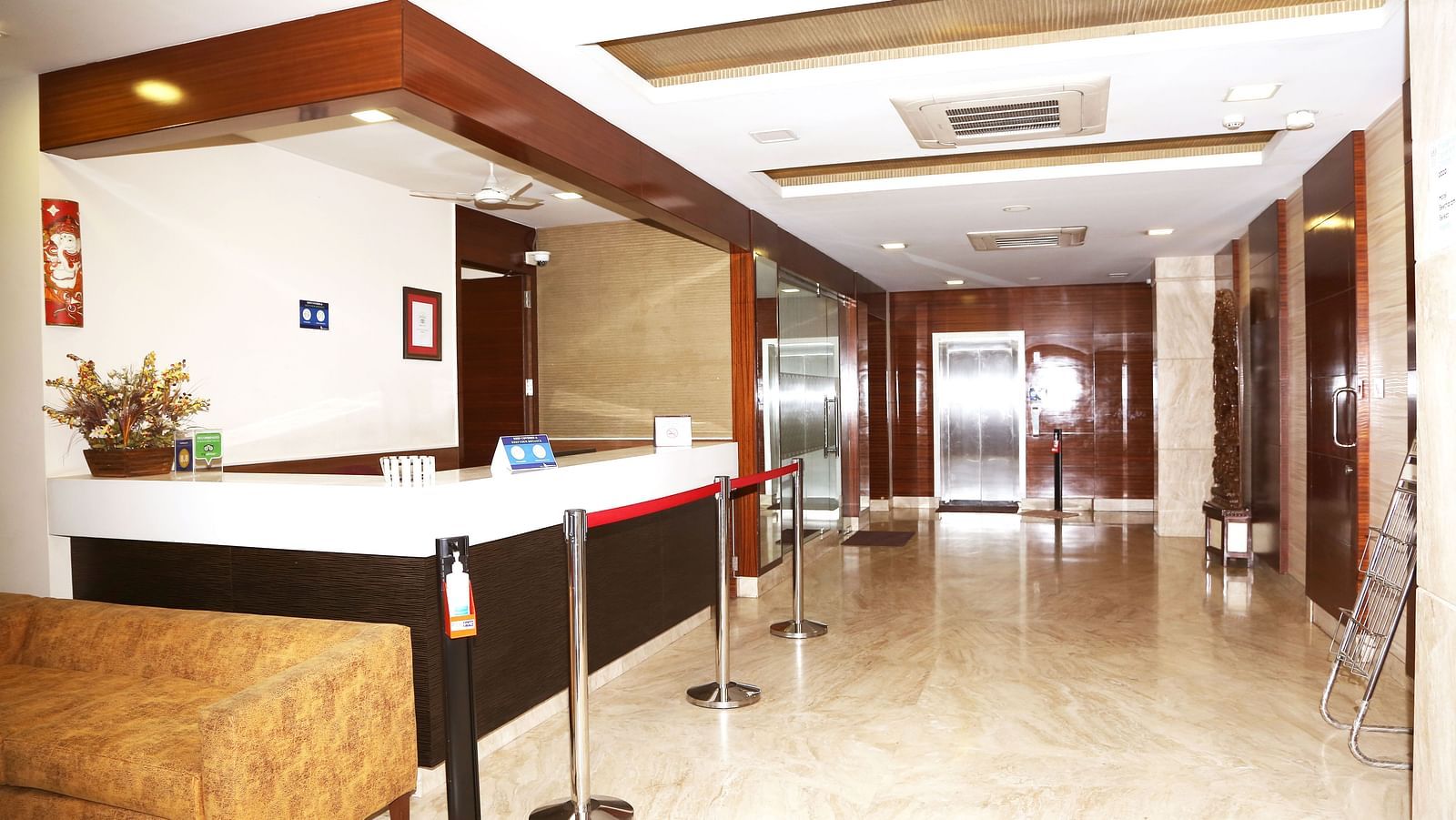Reception area with front desk and wooden wall panels at Fressotel Seetharam, Coimbatore