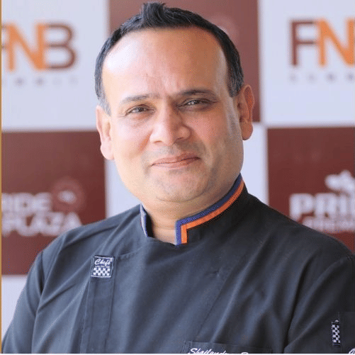 Culinary team member in chef coat at Pride Hotels Group.