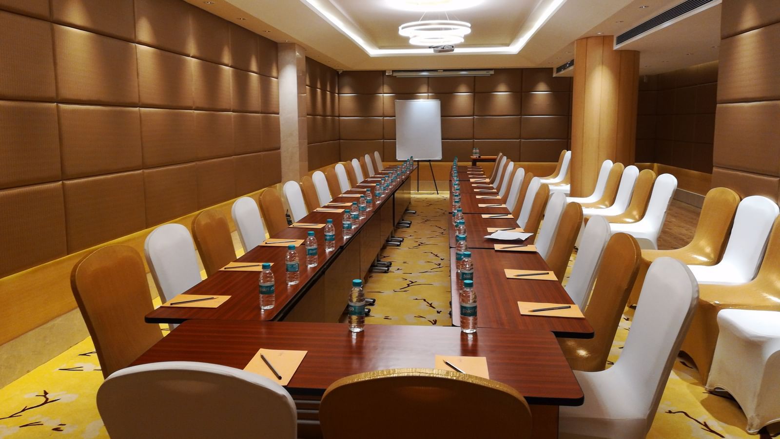 a meeting hall with a long rectangular table with chairs surrounding it - Hotel Fountain Tree By TGI - JP Nagar, Bangalore